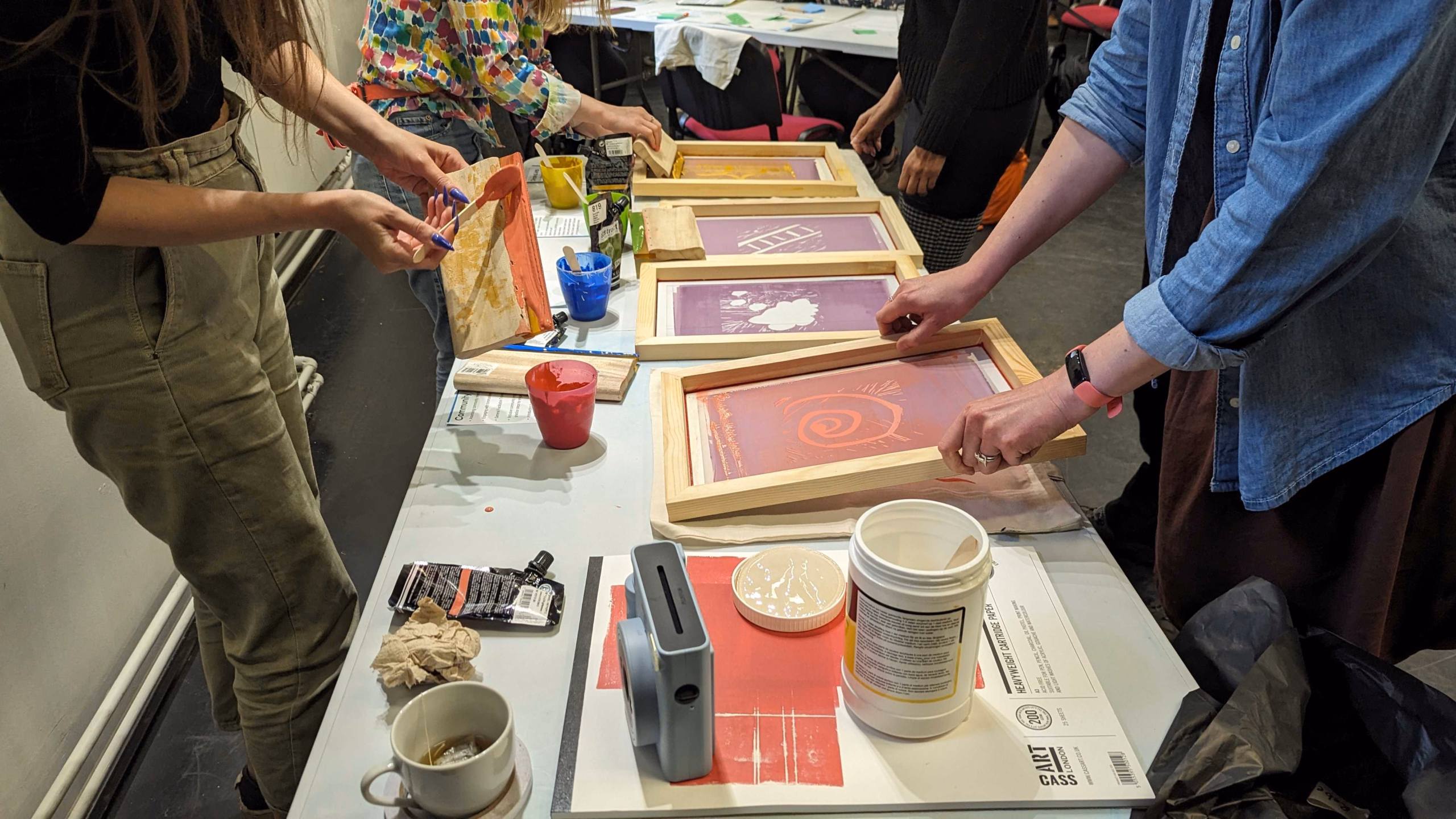 A group of people around a table taking part in an art task